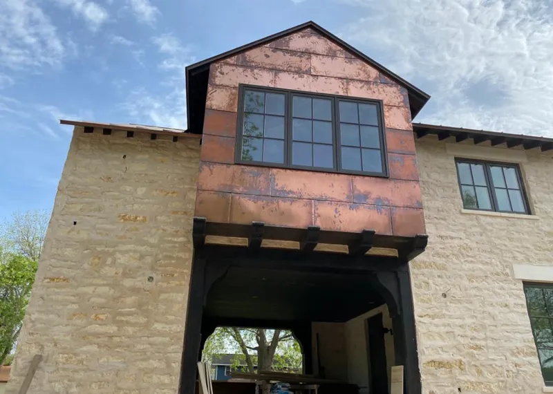 Copper metal panel facade on a stone building for Skylight Installation in Chillum